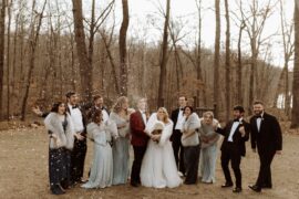 Bridal Party Spraying Champagne in Winter Woods