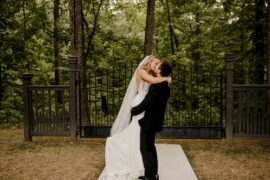 Bride and Groom Kissing in front of Gate
